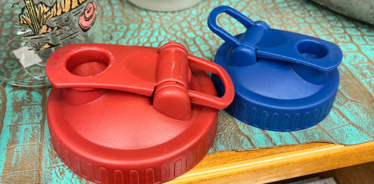 Drink lids with finger loop